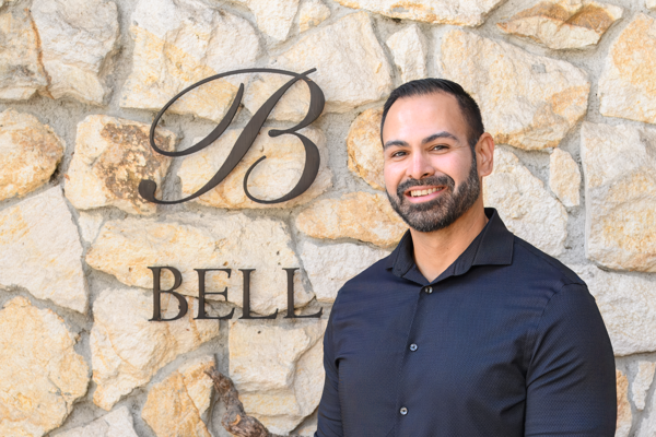Rob Vasquez, Tasting Room Manager at Bell Wine Cellars, holding a bottle of Bell Cabernet Sauvignon in the tasting area